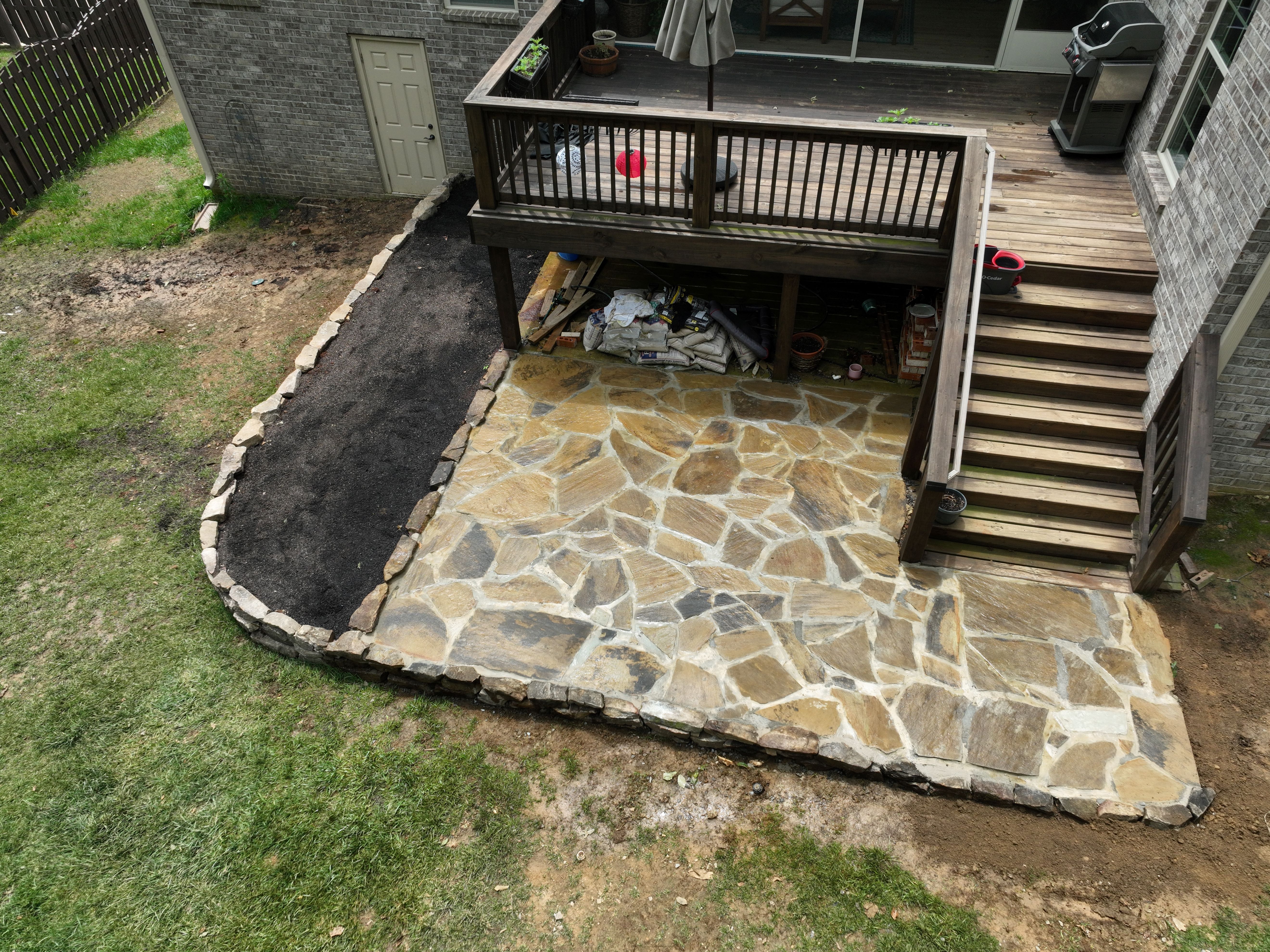 Natural stone retaining wall and Flagstone patio